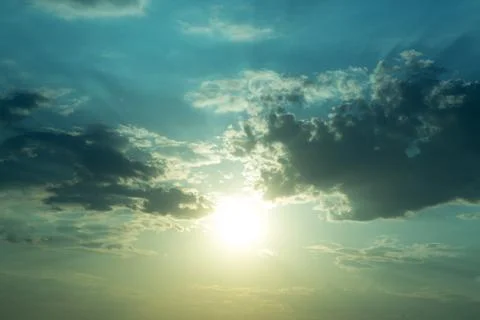 Large heavy clouds slowly float across the blue beautiful sky. Stunning Stock-Fotos