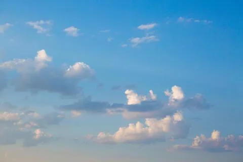 Large heavy clouds slowly float across the blue beautiful sky. Stunning 스톡 사진