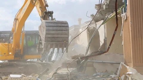 Large heavy construction machine picks up cement at demolition 스톡 동영상 125056889