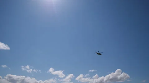 Large Helicopter fly across Blue Sky Pt1 of 1 Stock Footage 240919930
