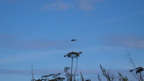 Large Helicopter fly across Blue Sky Handheld Pt1 of 2 Stock Footage 240920340
