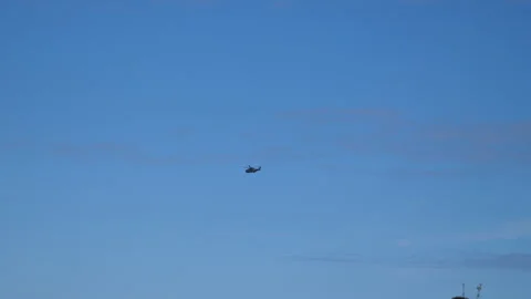 Large Helicopter fly across Blue Sky Handheld Pt2 of 2 Stock Footage 240921791