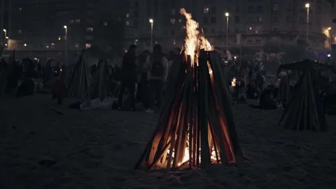 A large high bonfire on the beach in the city. A typical holiday of San Juan in Stock Footage 220462402
