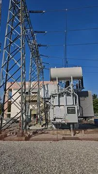 Large high voltage electrical power transformer with conservator tank. Stock Photos