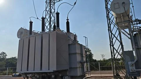 Large high voltage power transformer with cooling radiator. Stock Photos