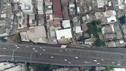 Large highway next to buildings in the city aerial Stock Footage 278817543