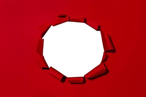 Large hole in red paper, empty space for advertising text in torn paper Stock Photos