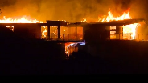 A large home burns at night during the 2017 Thomas fire in Ventura County, Stock-Footage 83225201