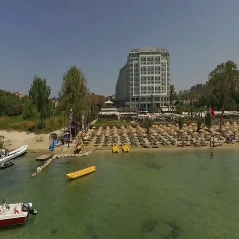 Large hotel and palm trees on the beach in Turkey Stock Footage 69560060