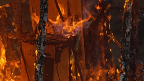 Large house fire ablaze with dangerous flames blue and orange flames from a Stock Footage 232339024