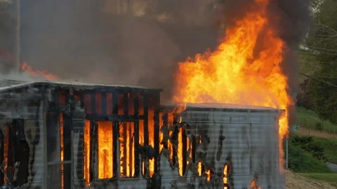 Large house fire burning. Slow motion. Trailer home ablaze with large flames and Stock Footage 229816878