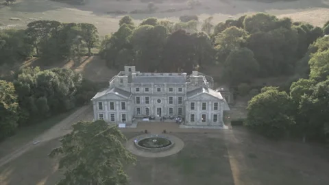 A large house with a large yard and a tree in front of it Stock Footage 301618107