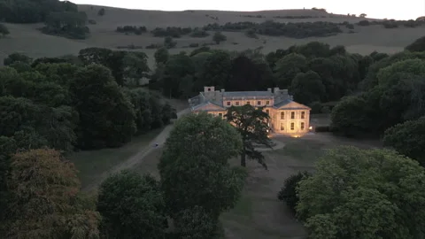 A large house with a large yard is lit up at night Video stock 301629197