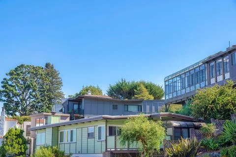Large houses surrounded by trees against the sky background in San Francisco, Stock Photos