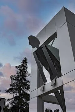 Large human statue with modern architecture in google campus during sunset Stock Photos