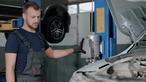 Large hydraulic jack. auto mechanic repairs the gearbox in a modern car. Stock Footage 239471325