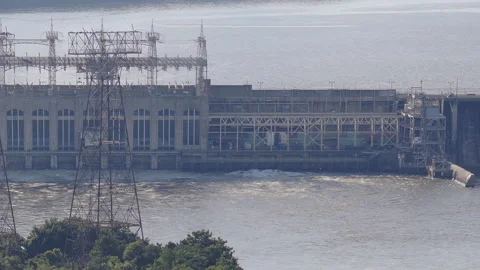 Large hydroelectric power plant generating energy on a wide river Stock-Footage 344549535