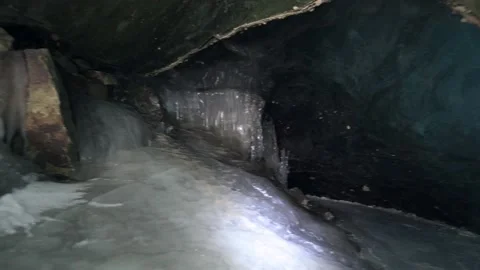 A large ice cave in a glacier in the mountains Stock Footage 234445945