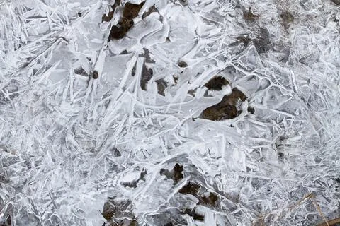 Large ice crystals formed a surface above the stream Stock Photos