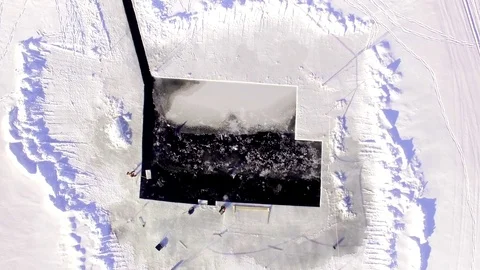 Large ice cubes are sawn of the ice cover of a frozen lake Stock Footage 72790770