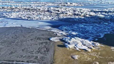Large ice floes and sheets covering a water surface making textured background Stock Footage 332971427