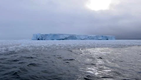 Large iceberg at edge of pack ice in antarctic ocean, Antarctica Stock Photos