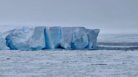 Large iceberg at edge of pack ice in antarctic ocean, Antarctica Stock Photos