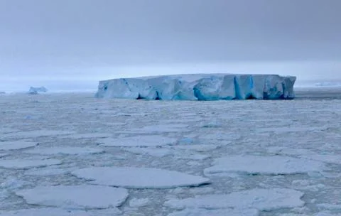 Large iceberg at edge of pack ice in antarctic ocean, Antarctica Stock Photos