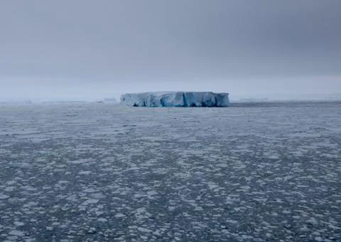 Large iceberg at edge of pack ice in antarctic ocean, Antarctica Stock Photos