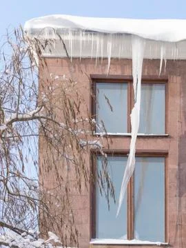 Large icicles on a red building Stock Photos