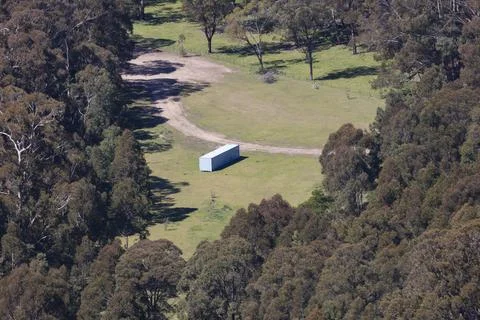 A large implement shed in a valley in regional Australia Stock Photos
