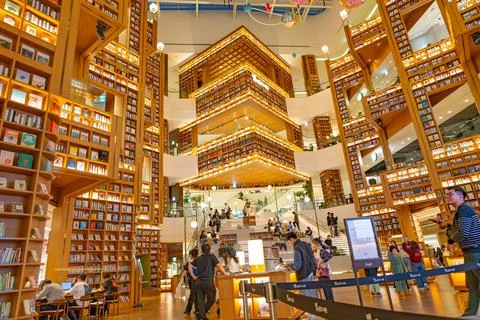 Large Indoor Library Atrium with Hanging Artwork and Crowds in Seoul Stock Photos