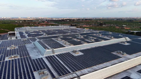 Large industrial building rooftop covered with extensive solar panel arrays Stock Footage 333439300