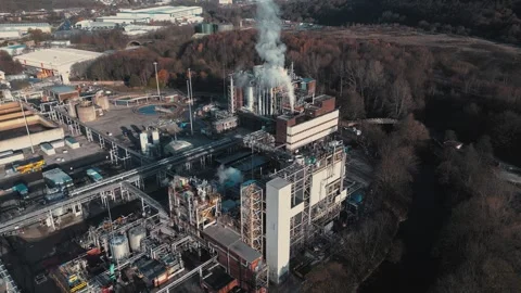 Large industrial complex emits smoke from tall chimneys. Steel structures and Stock Footage 345669143