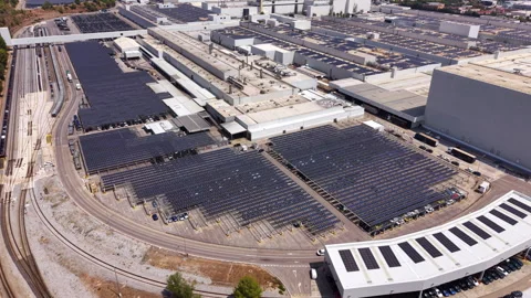 Large industrial complex with extensive rooftop and carport solar panel arrays Video stock 342752594