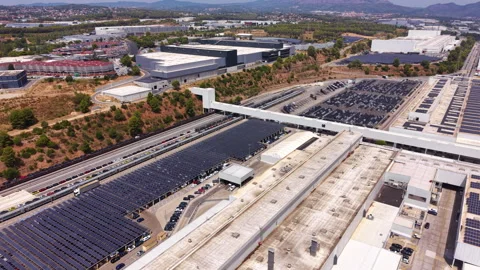 Large industrial complex with extensive solar panel arrays covering parking Stock Footage 342752713