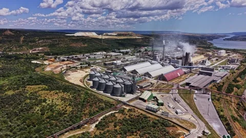 Large industrial complex surrounded by land and water near river Stock Footage 339649104