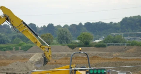 Large Industrial Crane on a Construction Site. Moving Yellow Digger on Quarry Stock Footage 94714767