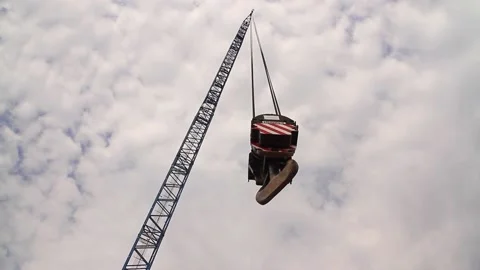 Large industrial crane hook at construction site swinging on cables in close-up Stock Footage 224377254