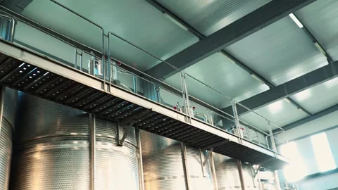 Large industrial metal wine fermentation tanks with stainless steel Stock Footage 318833562