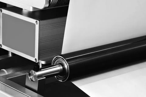 A large industrial offset printing machine prints an image on packaging film. Stock Photos
