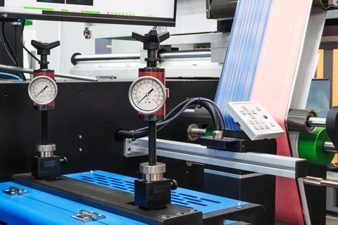 Large industrial offset printing machine prints an image on packaging film. t Stock Photos