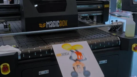 Large industrial packaging printer is printing colorful promotional material 動画素材 347245610