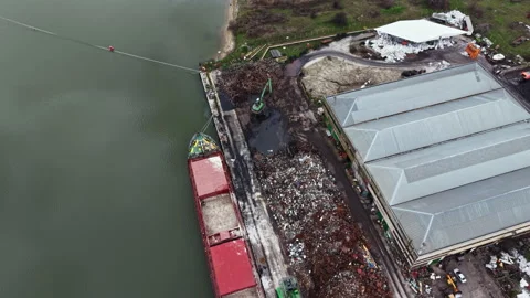 Large industrial site with several containers and a waste collection area near a Video stock 336535200
