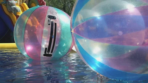 Large inflatable balls floating in swimming pool Stock-Footage 71660676