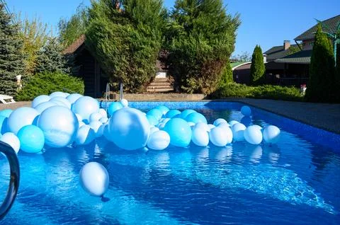 Large inflatable blue balls in the pool Stock Photos