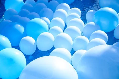 Large inflatable blue balls in the pool Stock Photos