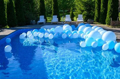 Large inflatable blue balls in the pool Stock Photos
