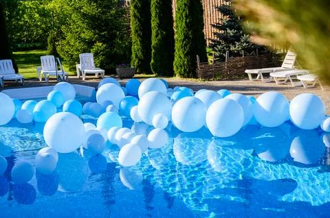 Large inflatable blue balls in the pool Stock Photos