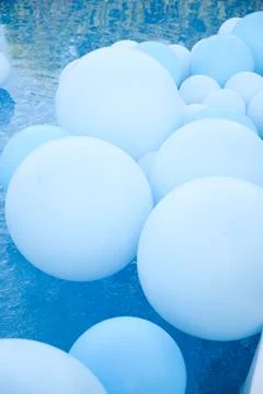 Large inflatable blue balls in the pool Stock Photos